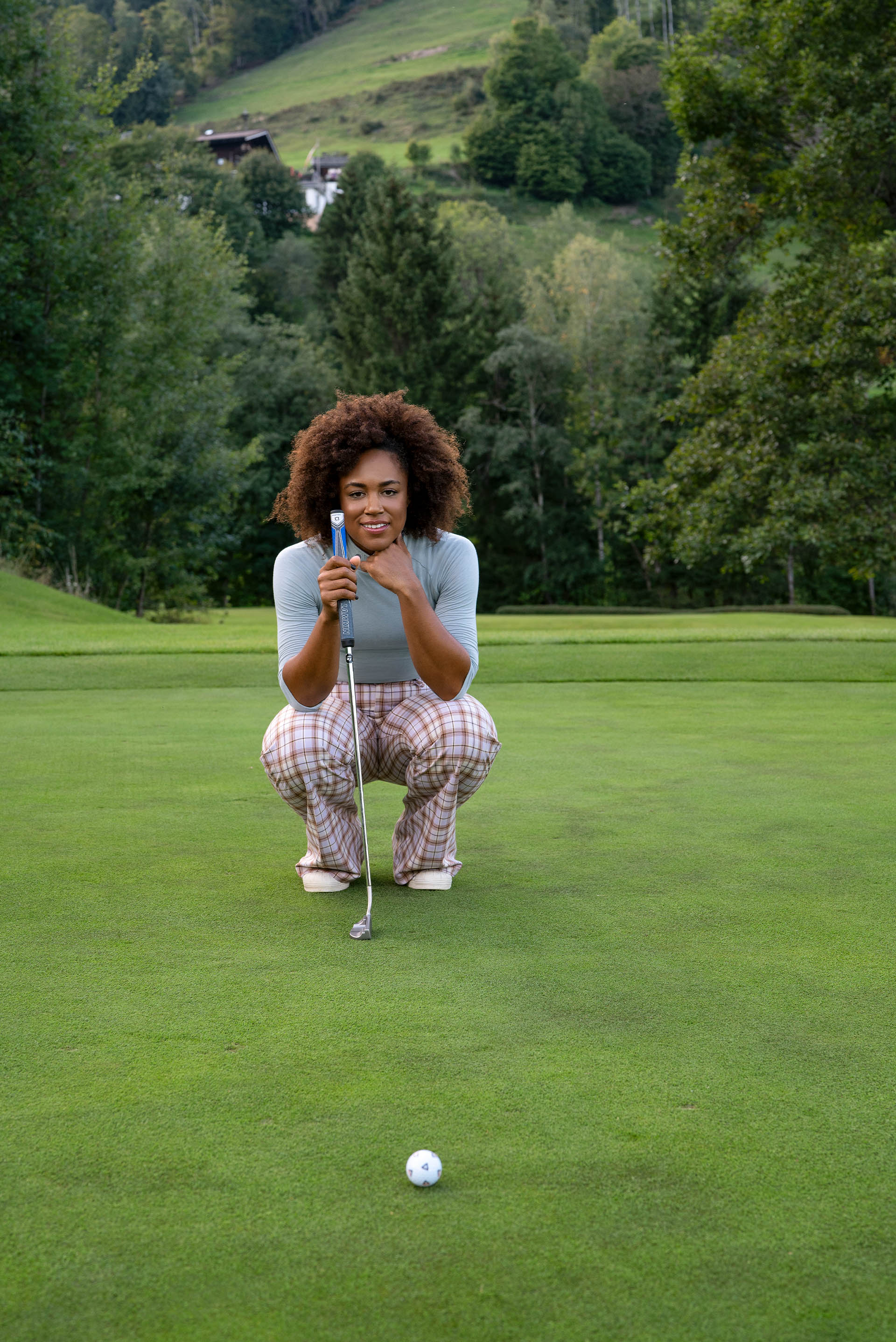 Troy Mullins looks intently at a golf ball.