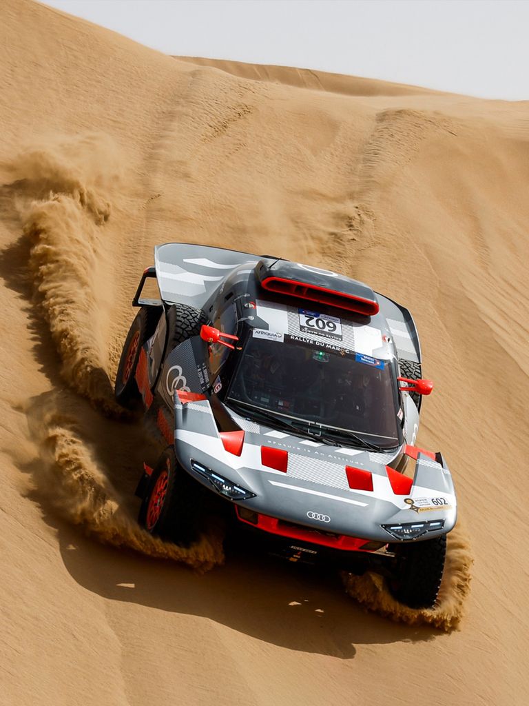 An Audi RS Q e-tron driving down a dune.