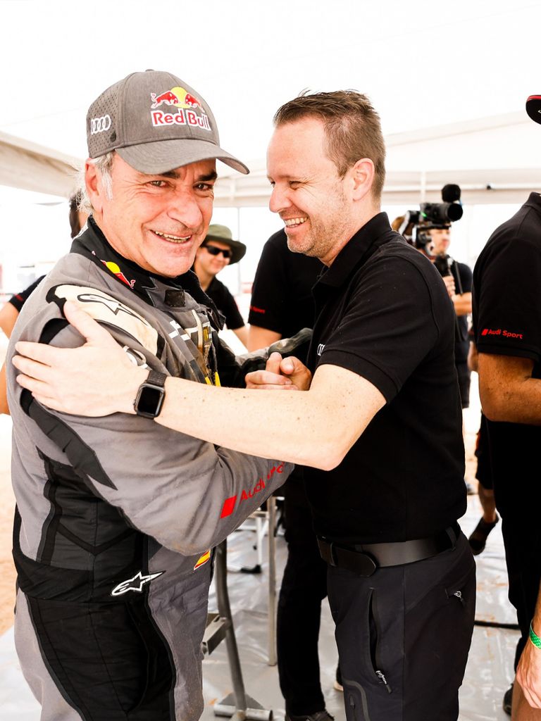 Carlos Sainz and Rolf Michl shaking hands.