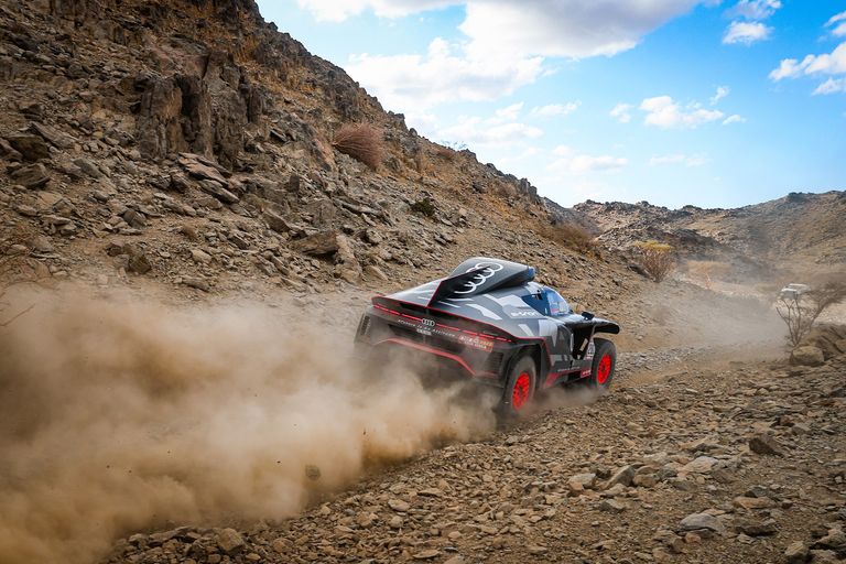 Rear view of the Audi RS Q e-tron on a stony track section