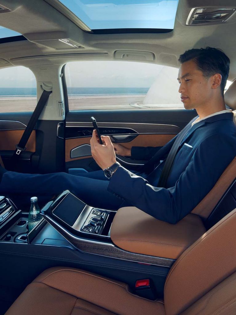 Man enjoys the space in the rear of the Audi A8 L